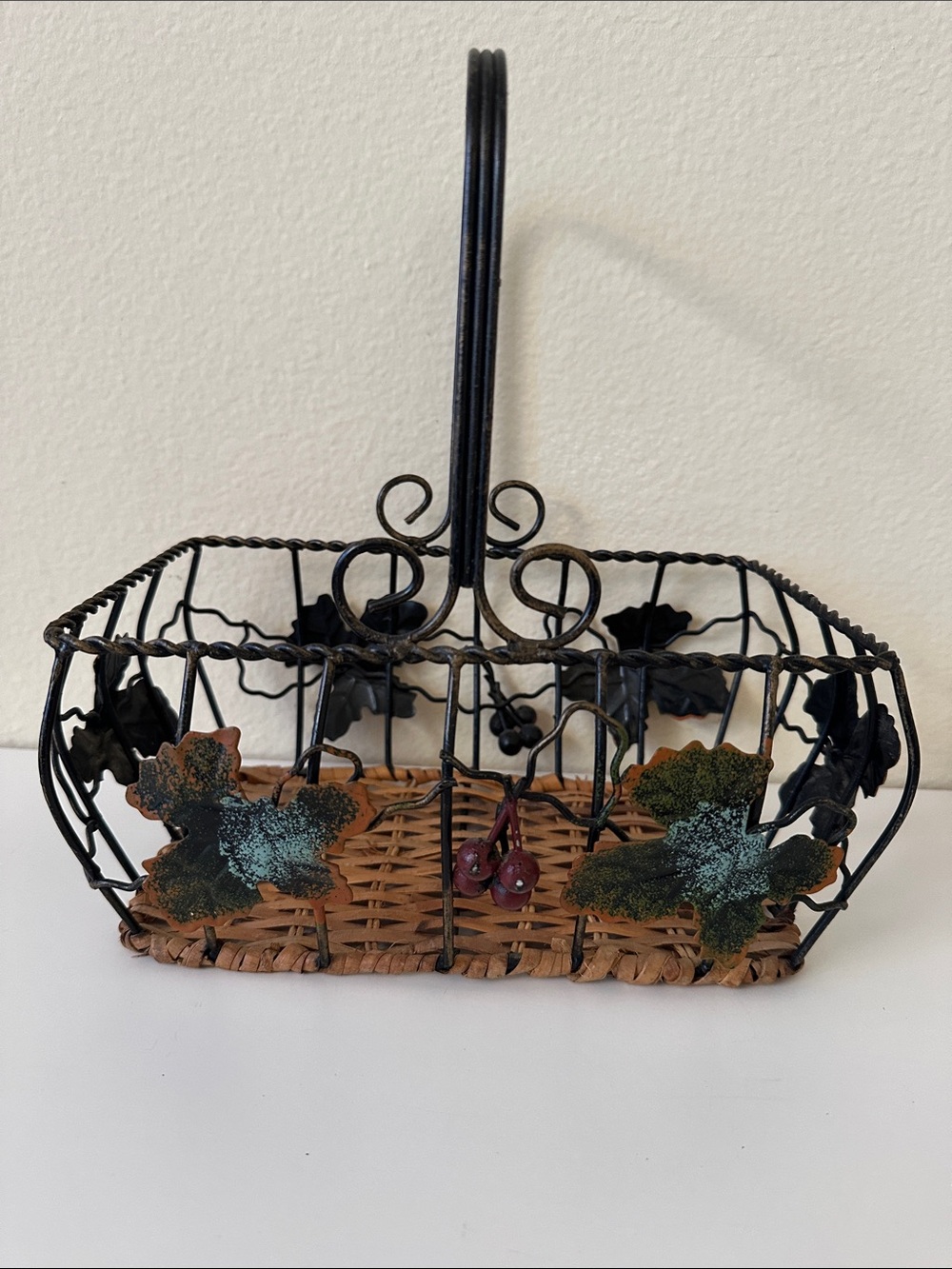 Black Metal and Brown Woven Decorative Basket with Green Leaf Accents